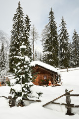 Alpine hut in winter in the Alps. Winter Landscape in a Forest near Lake Antholz Anterselva, South Tirol, Italy