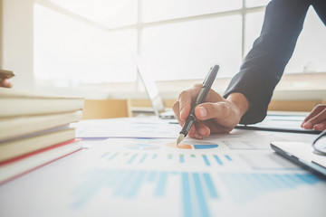 Business concept. Business people discussing the charts and graphs showing the results of their successful teamwork. Selective focus.Accounting