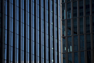Perspective and underside angle view to textured background of modern glass building skyscrapers