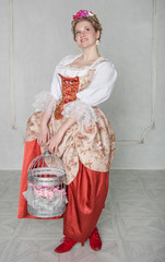 Beautiful woman in old-fashioned medieval dress smiling