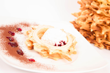 Polish-Lithuanian traditional spit cake ('tree cake') -sekacz (polish) or sakotis (lithuanian) served with some ice-cream on a white background