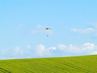 A man practicing extreme sport with paraglider with motor