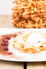 Polish-Lithuanian traditional spit cake ('tree cake') -sekacz (polish) or sakotis (lithuanian) served with some ice-cream on a wooden background