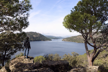 Man contemplates from the top the dam of San juan, Madrid, Spain