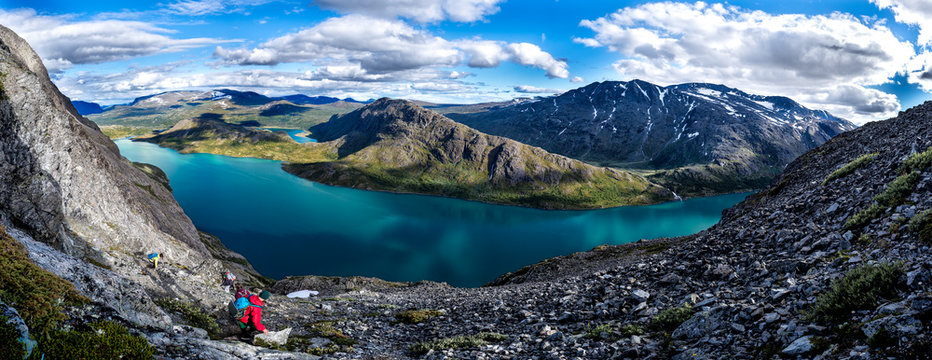 Group of tourists with backpacks in bright clothes