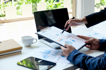 Business concept. Business people discussing the charts and graphs showing the results of their successful teamwork. Selective focus.Accounting