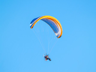 A man practicing extreme sport with paraglider with motor