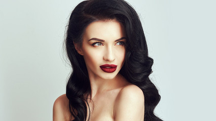 Fototapeta premium Fashion makeup and Hairstyle curls. Beautiful model with long curly hair.