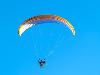 A man practicing extreme sport with paraglider with motor