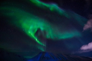 Fototapeta premium The polar Northern lights in the mountains of Svalbard, Longyearbyen, Spitsbergen, Norway wallpaper