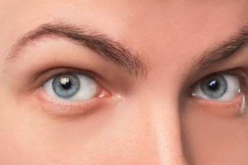 Fototapeta premium Beautiful blue man eyes close up