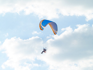 A man practicing extreme sport with paraglider with motor