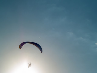 A man practicing extreme sport with paraglider with motor