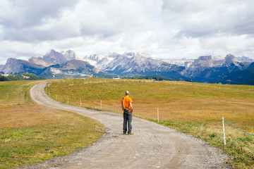 Hiker admires rocky mountains in the Dolomite