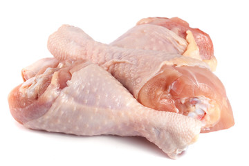 Three raw chicken drumsticks isolated on white background