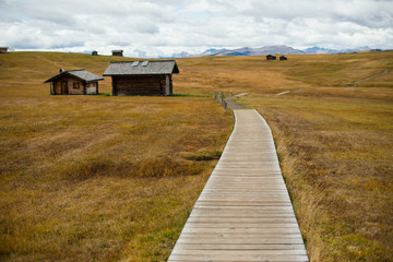 Wooden path to the old house in the mountains