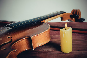 violin and candle on a table