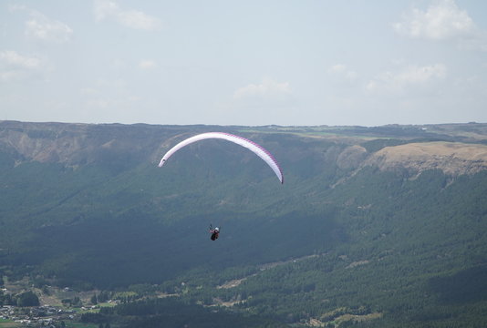 熊本県の阿蘇外輪山　観光地として有名な大観峰の上を飛ぶパラグライダー