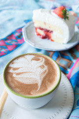 coffee cup and delicious cake strawberry and relax time moblie on table in coffee shop