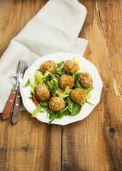 Falafel.Vegan chickpeas balls on a plate with fresh salad on wooden background