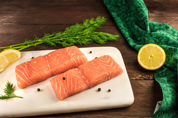 Two slices of salmon on dark background with copyspace