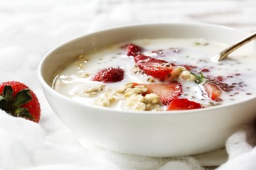Strawberry Chia overnight oats served in a white bowl, selective focus