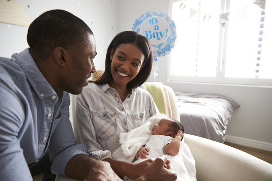 Parents Home From Hospital With Newborn Baby In Nursery