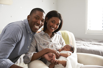 Portrait Of Parents Home from Hospital With Newborn Baby
