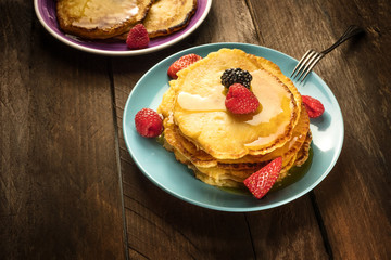 Homemade pancakes with fresh fruit and honey