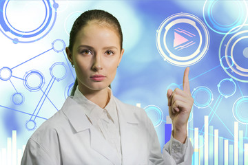 closeup portrait  beautiful young woman scientist dressed in a white robe on the background of a blue charts