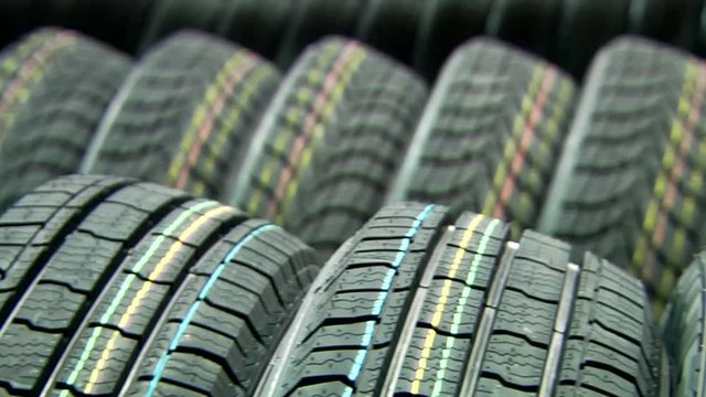 New stacked tires at the tire production plant panoramic and tilt video footage