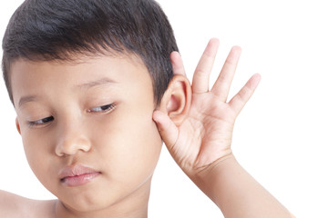 Little boy hearing something, hand to ear gesture on white background.