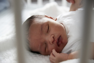 Obraz na płótnie Canvas Newborn Baby Sleeping In Nursery Cot