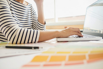 Graphic design and color swatches and pens on a desk. Architectural drawing with work tools and accessories.