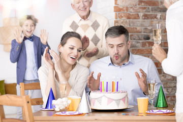 Man blowing out candles