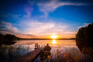 Foto op Plexiglas Sunset over the fishing pier at the lake in Finland © nblxer