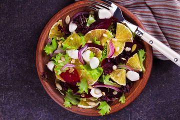 Mozzarella, Orange, Beetroot, Red Onion, Nuts and Seeds Salad. View from above, top studio shot
