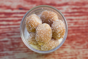 Tamarind candies mix with sugar in a glass on wooden background