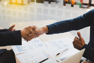 businessman handshaking and show a thumb up after meeting in office - teamwork, cooperation, agreement, acquisition concept