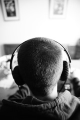 Back view of a man in headphones inside