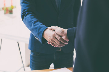businessman handshaking after meeting in office - teamwork, cooperation, agreement, acquisition concept