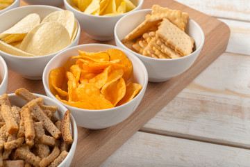 Pretzels in bowls on wooden table from above