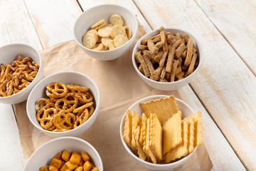 Pretzels in bowls on wooden table from above