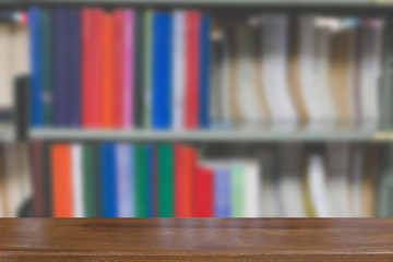 bookshelf in library with many books, blur background with selective focus wood table for display your product