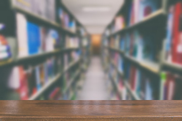 bookshelf in library with many books, blur background with selective focus wood table for display your product