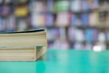 A stack of old books on table with blur book in library, education background