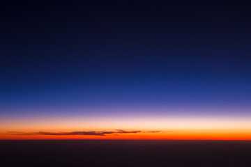 Beautiful panorama of sunset from height of airplane. Dark sunrise