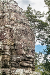 Fototapeta premium Giant face stone carving faces of Bayon temple in Angkor Thom, Siemreap, Cambodia