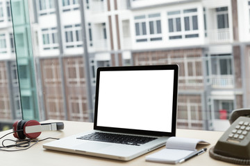 Fototapeta premium Headphones, Laptop, telephone on a wooden Desk