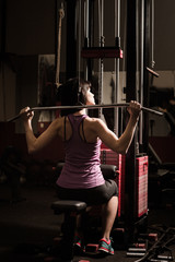 Modern business woman next to a fitness machine at a fitness lesson